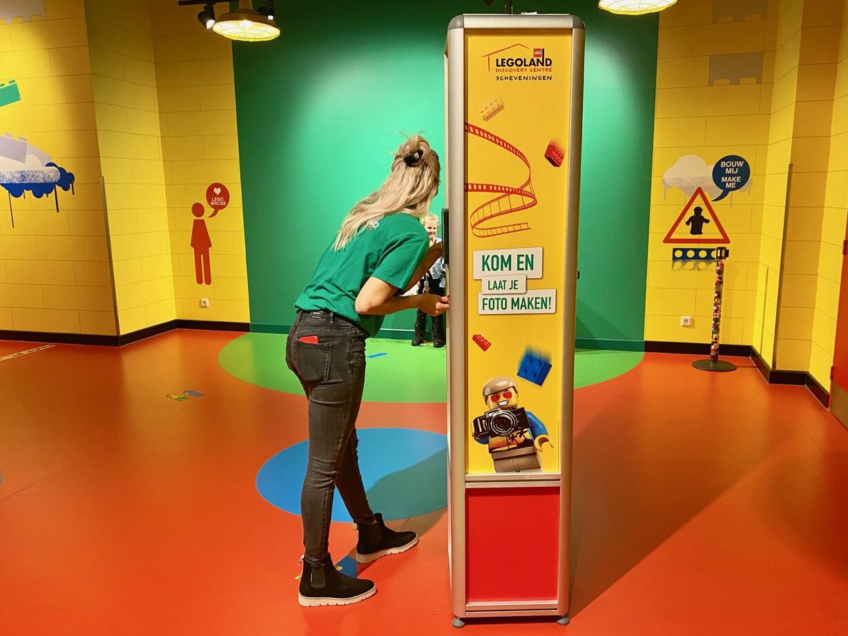 Staff taking green screen image of guests at Legoland Discover Centre.